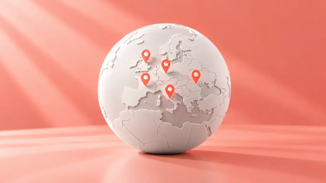 White globe with coral pins on several European countries