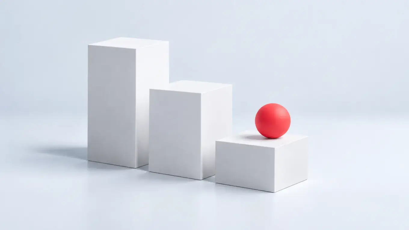Esfera roja apoyada en el más bajo de tres bloques blancos